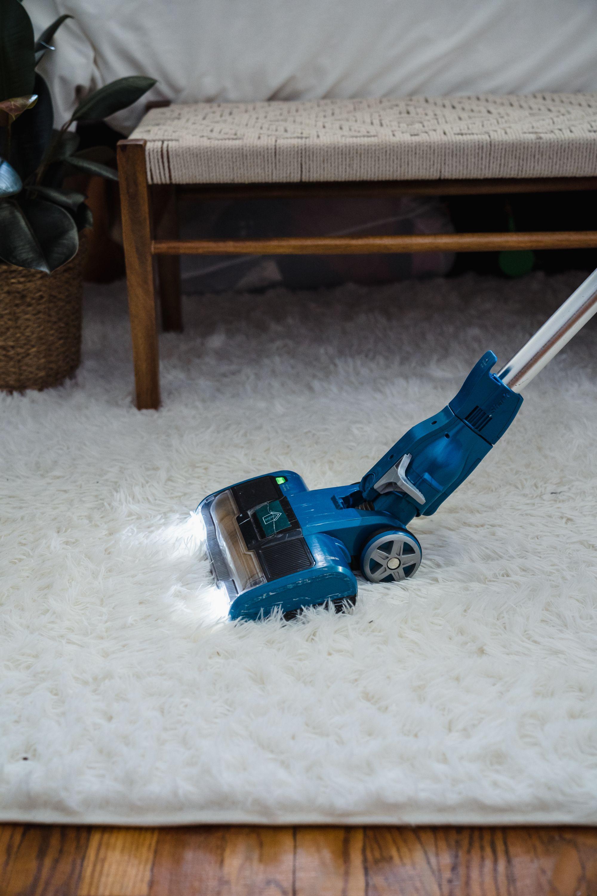 Vacuum cleaner on a soft white rug